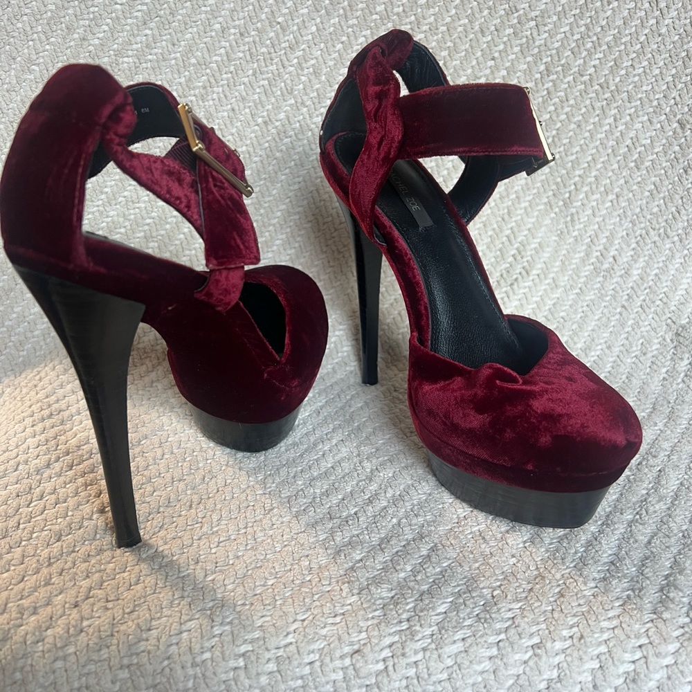 Burgundy Velour stiletto platform heels w/ gold Buckle around ankle. Snug fit.